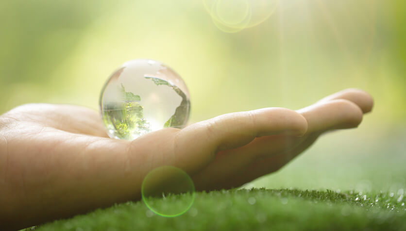 close-up-green-planet-your-hands-save-earth-min